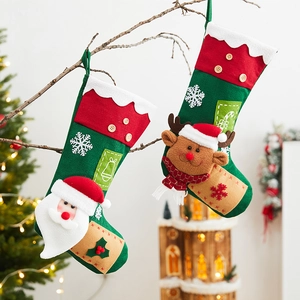 Hanging Christmas stockings with Santa and Reindeer appliques on a warm festive tree background