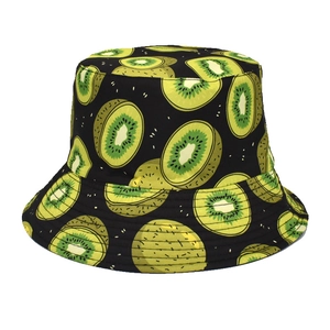 Detailed close-up of a black bucket hat featuring vivid kiwi fruit print on fabric