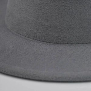 Detailed close-up showing the fine wool felt texture and stitching on a gray fedora hat