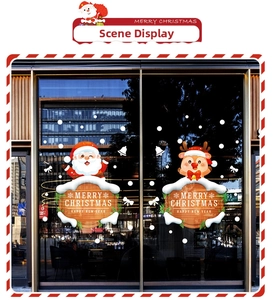 Close-up of Santa Claus and elk window stickers on a glass pane in festive retail setting