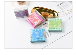 Detail of colorful double-headed cotton swabs in pastel pink, purple, blue and green