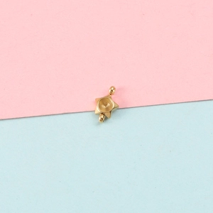 Close-up of golden star-shaped stainless steel pendant base with circular bezel setting