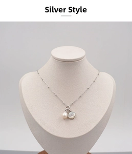 Detailed macro view of S925 silver necklace with white freshwater pearl and shell pendant