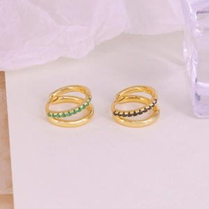 Detail of gold-plated double-layer crossover hoop earrings with green and black crystals