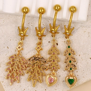 Detailed macro view of four golden belly rings featuring colorful marquise zircon stones