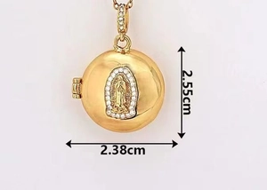 Detailed view of a gold-plated oval locket with cubic zirconia and dimension labels