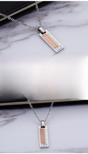 Detail of silver square pendant with rose gold panel, Love devotion text and zircon inlay