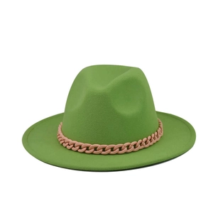 Detail of avocado green wool felt fedora featuring a contrast baby pink chunky chain trim