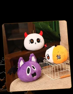 Plush Halloween toys featuring ghost, bat and pumpkin characters on a cozy wooden chair