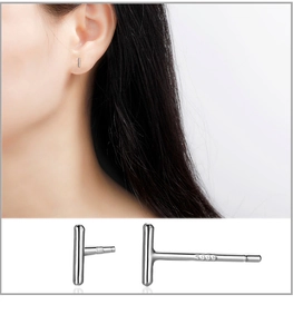 Macro view of S999 sterling silver bar stud earrings showing hallmark and model wearing