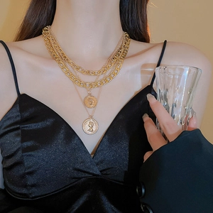 Detail of multi-layered gold necklace featuring vintage portrait coin pendants for women