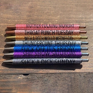 Close-up of 7 colorful glitter pens with bold Monday to Sunday swearing phrases