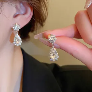 Sparkling diamond-encrusted water drop V-shape tassel jewelry set on a model