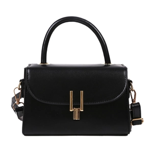 Classic black leather crossbody bag with gold U-shaped buckle and top handle