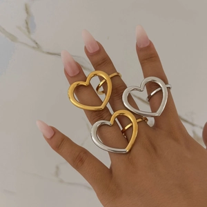 Elegant hollow heart rings in gold and silver finish shown on a marble background