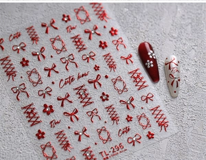 Detail of red metallic velvet bow nail stickers with star and ribbon patterns