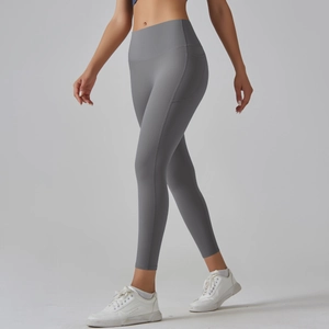 Close-up of high-waisted yoga leggings with functional side pockets in dark grey color