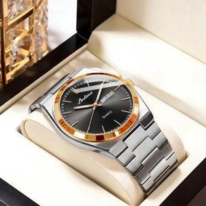 Close-up of a silver and gold steel watch with black dial and day-date display in a box