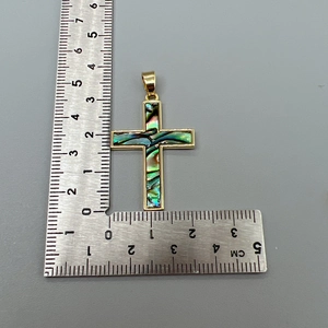 Detailed view of an abalone shell cross pendant in gold frame showing precise measurements