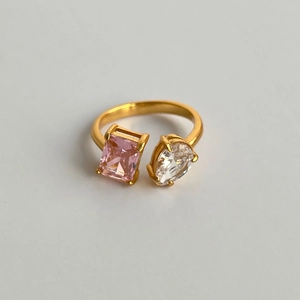 Macro detail of 18k gold plated ring featuring pink rectangle and clear pear zircons