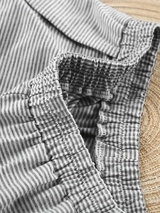 Detailed view of elastic waistband and striped knit fabric texture of lounge set