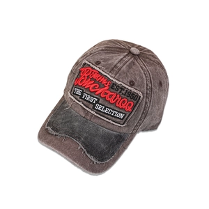 Close-up of vintage washed baseball cap with embroidered Buckaroo patch and frayed brim detail