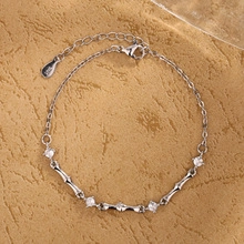 Detail of silver S925 bamboo style bracelet featuring white cubic zirconia accents