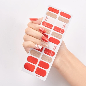 Close-up of waterproof adhesive nail stickers featuring red, glitter, and striped patterns