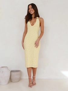 Detail shot of the V-neck halter design and delicate lace texture on yellow midi dress