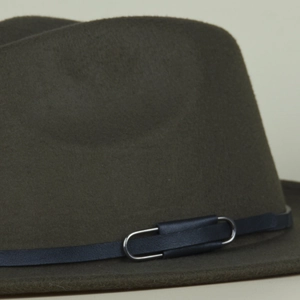 Close-up of olive green wool felt hat featuring a blue leather strap and metal buckle