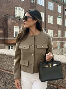 Brown wool short jacket with round neck and gold buttons in an elegant street style look