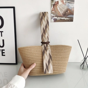 Minimalist woven cotton rope handbag with herringbone patterned handles and wooden ring