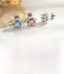 Detailed macro view of star-shaped titanium steel earrings with blue and pink zircon