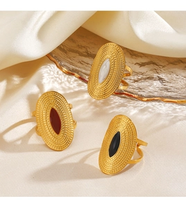 Detailed macro view of vintage geometric oval rings with black, red and white enamel inlays