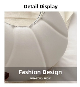 Close-up of the elegant pleated texture and zipper detail of the white dumpling bag