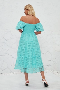 Detail of smocked back design and layered hem on a light blue summer maxi dress