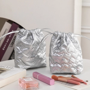 Silver PU leather drawstring pouches with butterfly and heart quilted textures for storage
