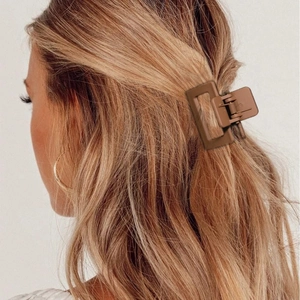 Brown rectangular matte hair claw clip shown on a female model with long hair