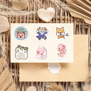 Close-up of cute cartoon stickers including pink bears and hamsters on a rustic wooden background