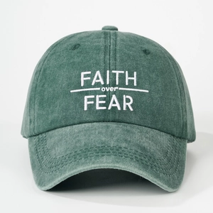 Retro dark green washed baseball cap with white Faith Over Fear embroidery detail