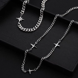 Men's double-layered titanium steel star cross necklace on a black textured tray