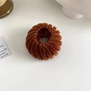 Detail of expandable caramel velvet bird nest hair ring for high ponytail styling