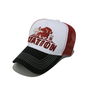 Detail of red mesh trucker hat with 3D STATION embroidery and white bull graphic