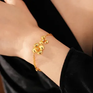 Vintage gold-plated floral bracelet with matte flower petals on a female model wrist