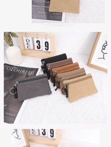 Flat lay of colorful canvas coin purses with metal keychains and a minimalist aesthetic