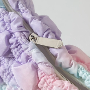 Close-up of fluffy macaron gradient cloud bag with polished silver metal zipper detail