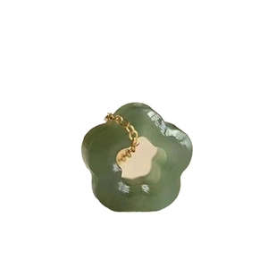 Exquisite green jade plum blossom pendant with gold buckle on a clean white background