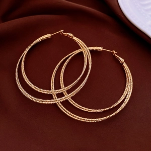 Close-up of 14K gold plated multi-layer hoop earrings with textured metallic finish