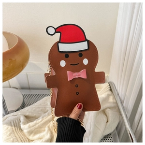 Detail of gingerbread man crossbody bag with golden chain and festive Christmas hat