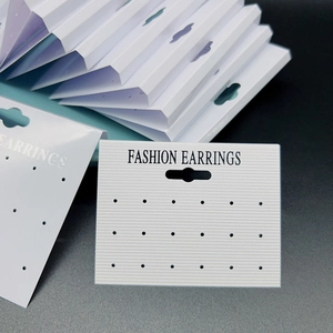 Detail of white 18-hole PVC earring display cards with hanging hooks for jewelry hanging